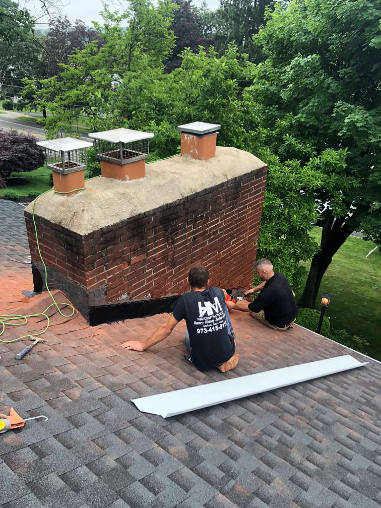HM Construction chimney masonry repair on a residential roof in Bergen County, NJ