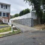 Finished retaining wall beside residential driveway