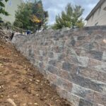 Finished stone retaining wall on residential property