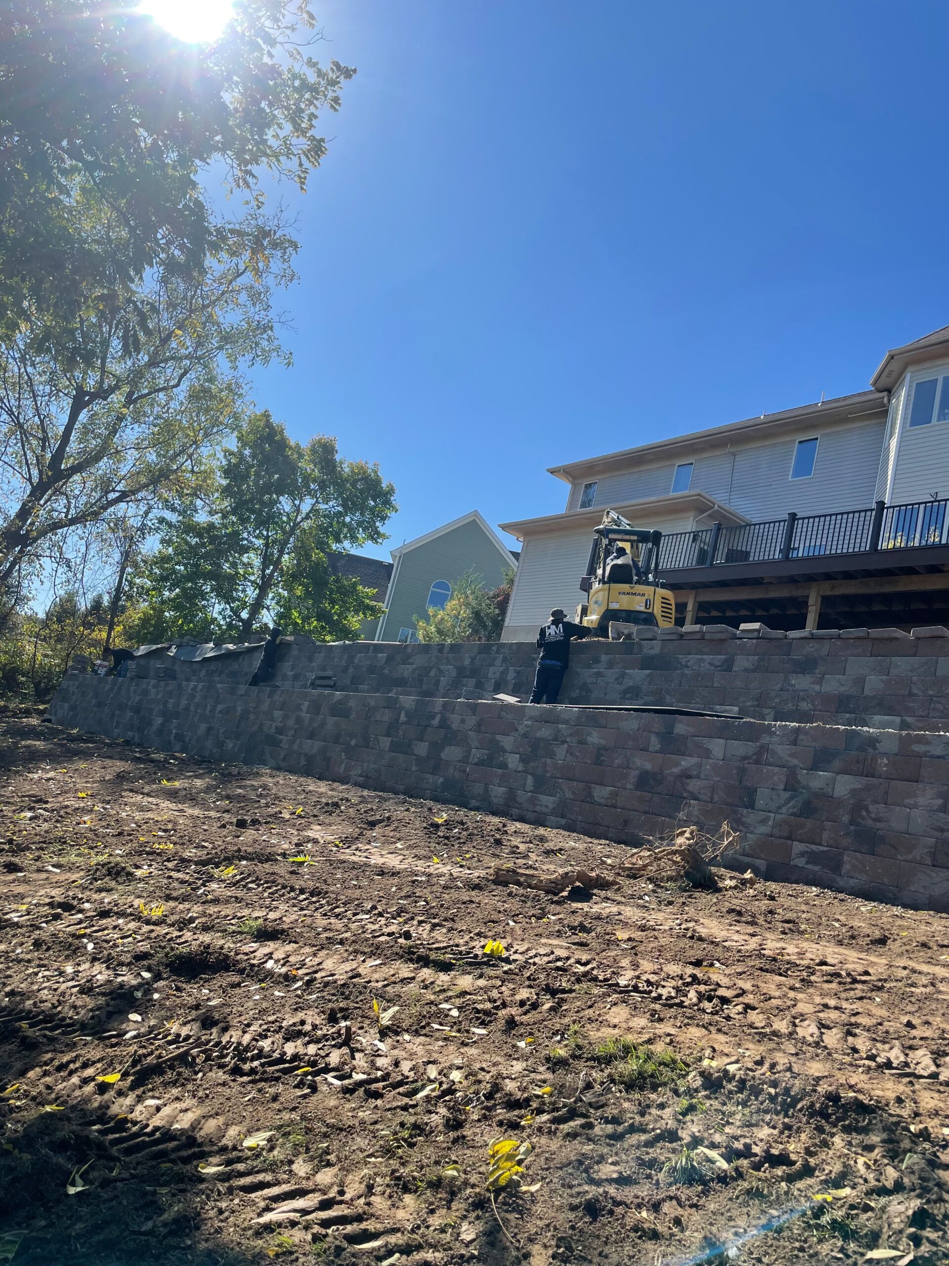 Large retaining wall behind residential home