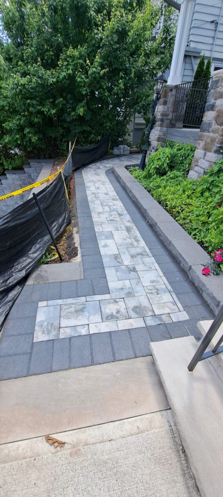 Modern gray paver walkway with dark border