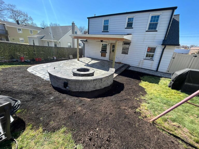 Paver patio with fire pit and seating wall