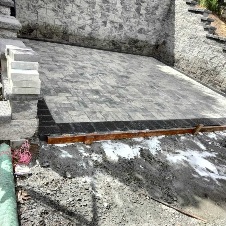 Paver patio next to masonry retaining wall