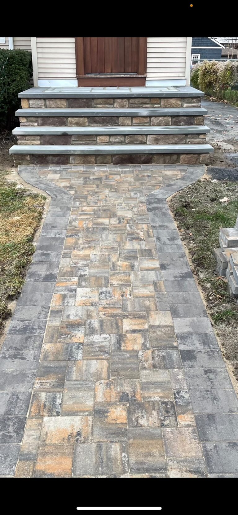 Paver walkway leading to stone front steps