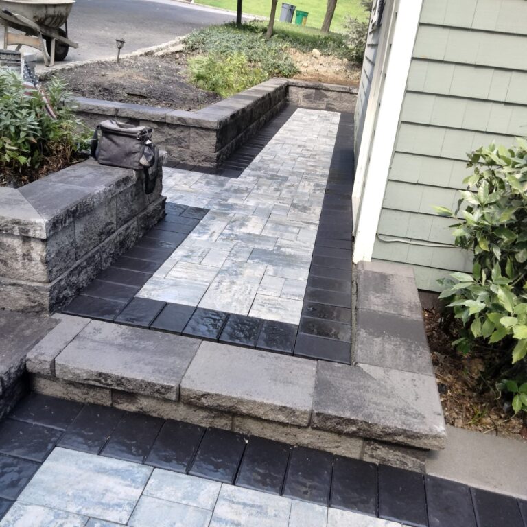 Paver walkway with retaining wall and dark border