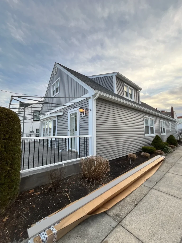 Completed residential siding installation by HM Construction