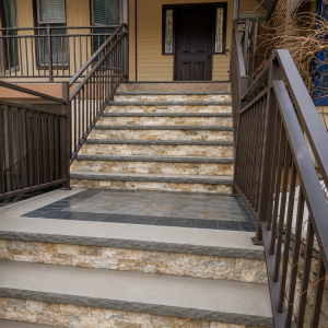 Large stone front entrance staircase with black railings in Wayne NJ
