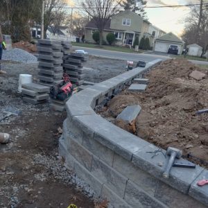 Curved retaining wall installation in progress