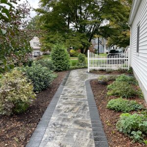 Landscaped paver walkway with dark border