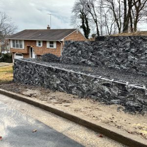 Large stone retaining wall along residential street
